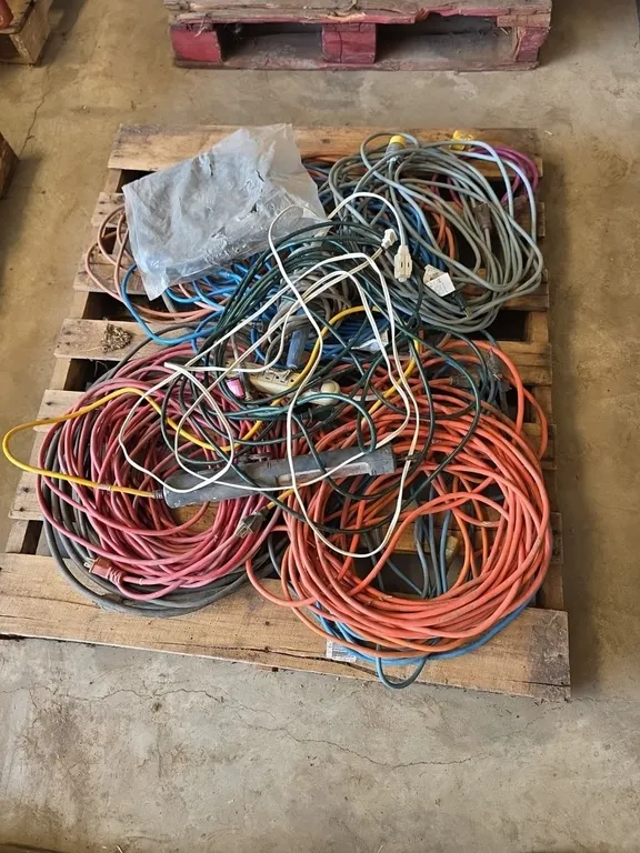 Pallet of electrical cords, power strips and trouble light