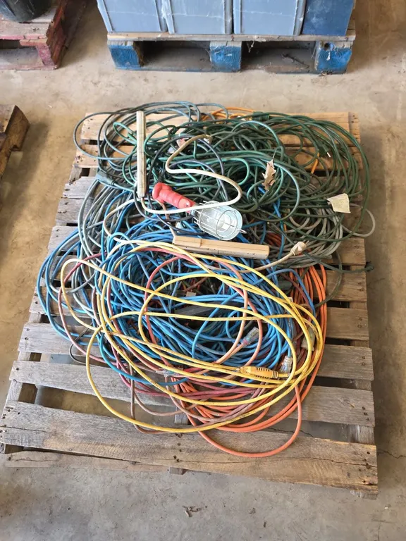 Pallet of electrical cords, power strips and trouble light