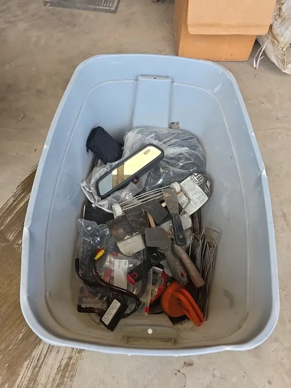 Tote of paint scrapers, unused lawn mower deck wheels and automotive accessories