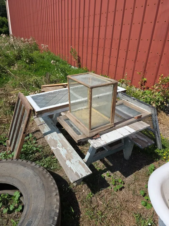 Wood picnic table and large quantity of Antique windows and barn windown
