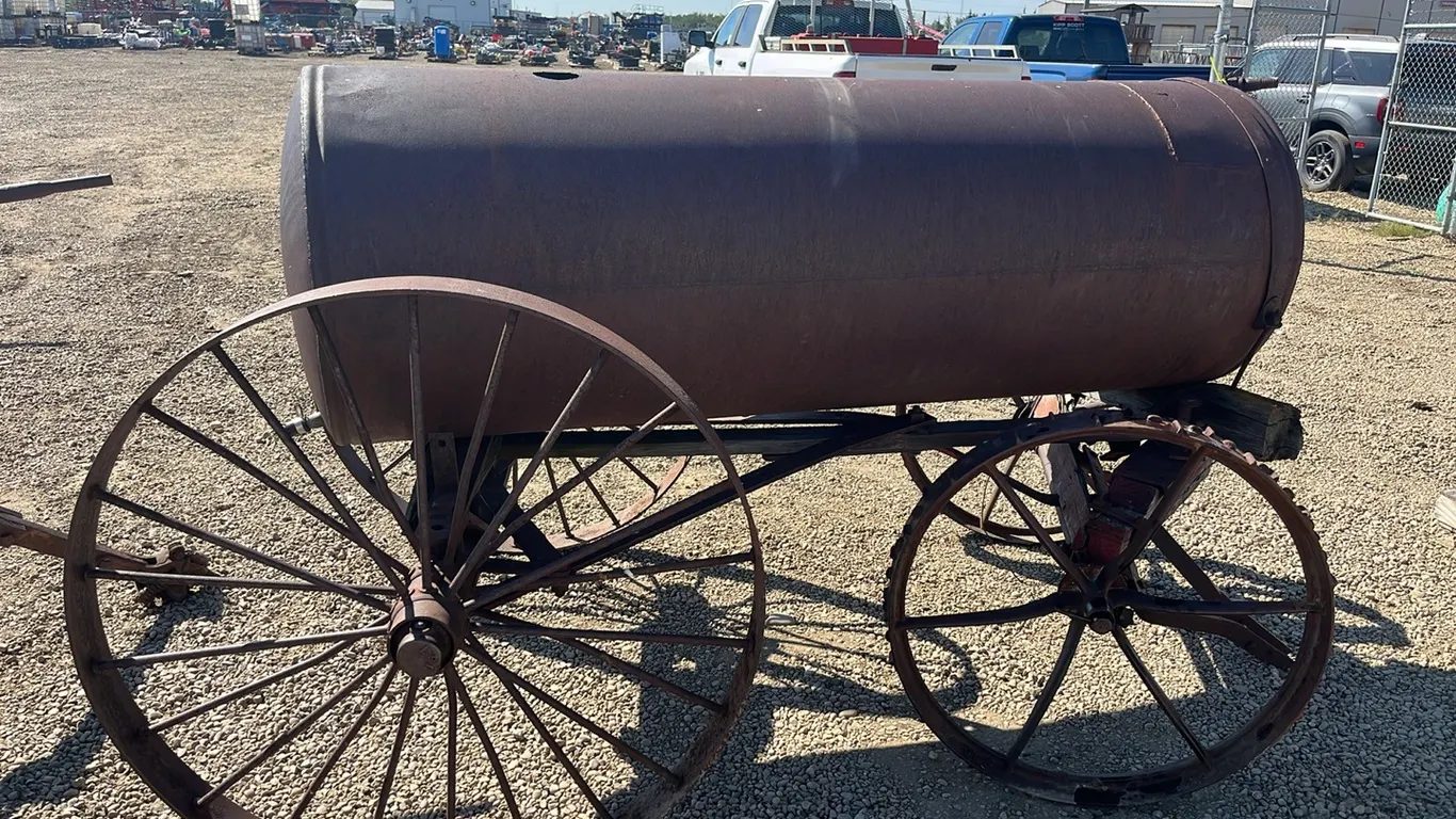 VINTAGE WATER TANK ON 4 STEEL WHEELS