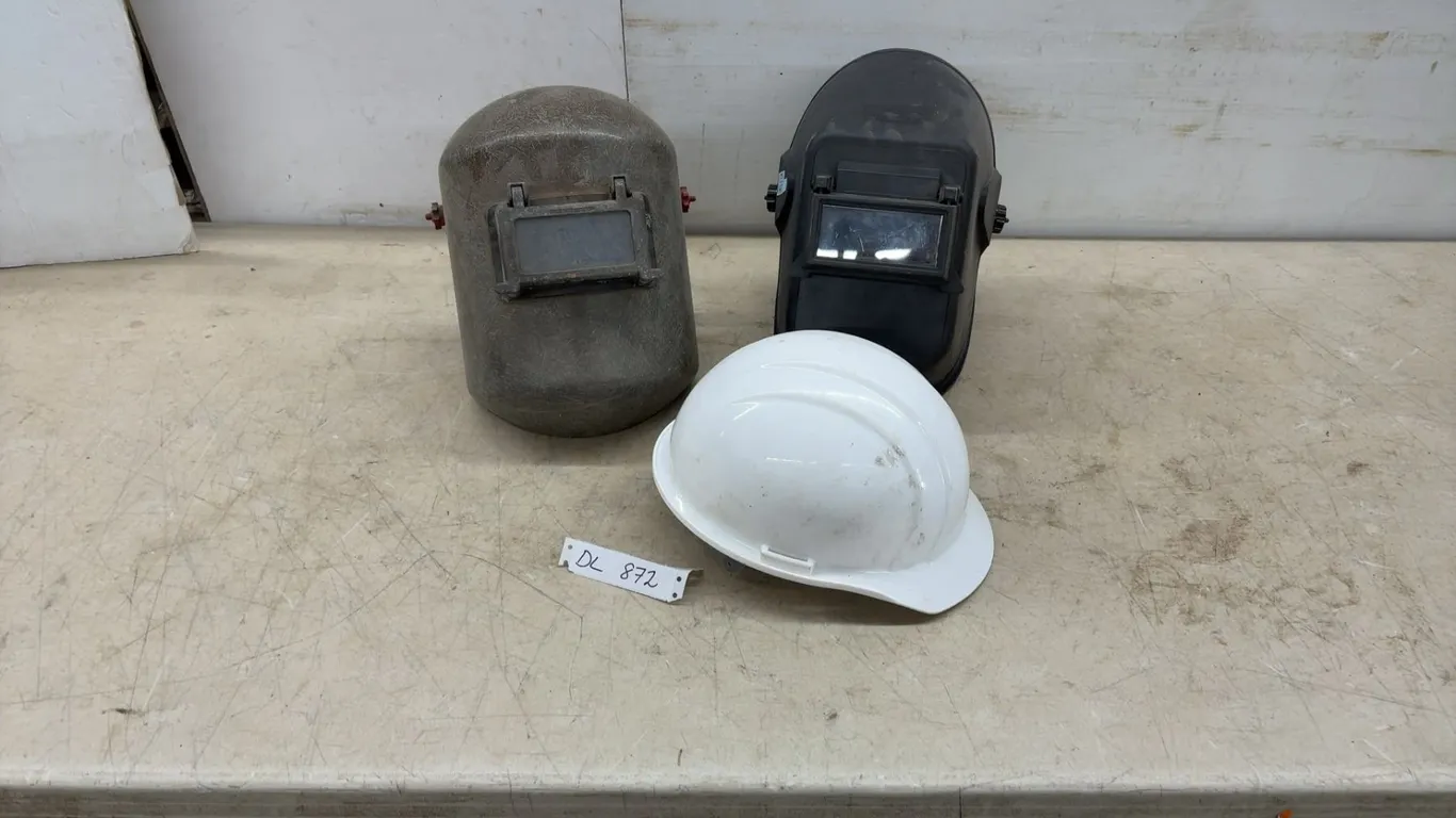 Two Welding Helmets and White Hard Hat Safety Equipment