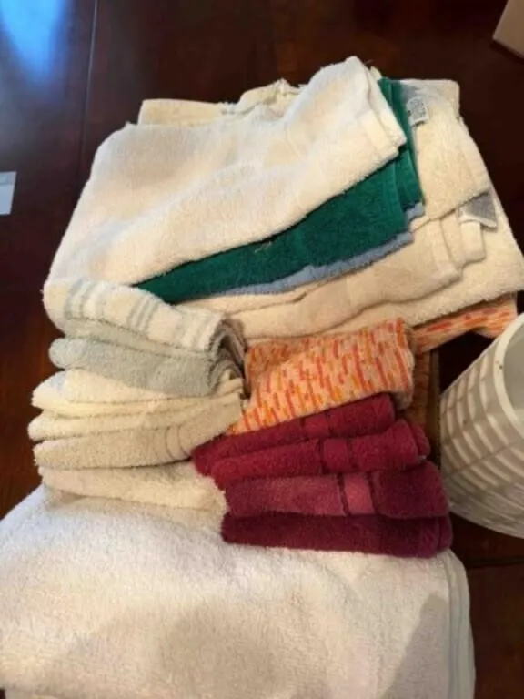 Bathroom towels and white trash can