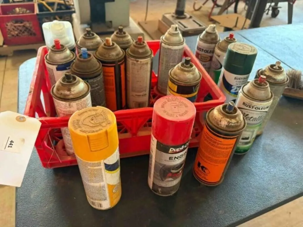 3 crates partially used spray cans