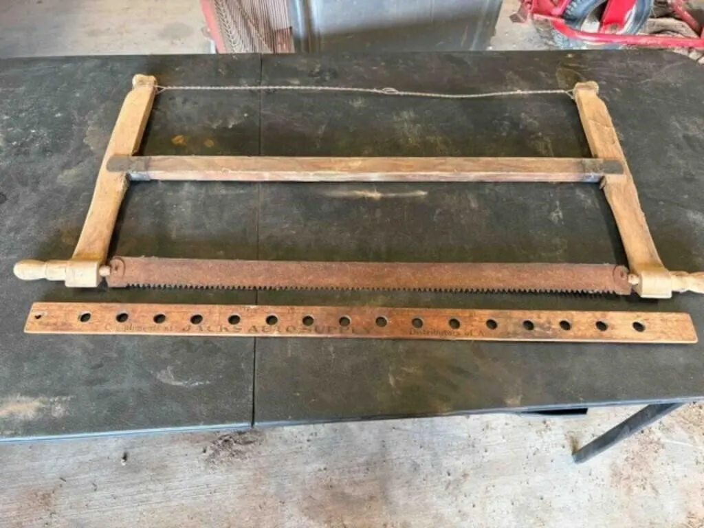 vintage hand saw and yard stick