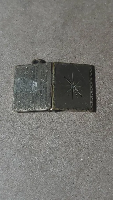 Unmarked Rectangular Book-Form Locket Pendant with Starburst Engraving and Clear Stone Accent, Hinge