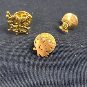 Three Gold-Tone Military-Style Pin Badges: Liberty Bell, Maple Leaf, and Naval Ship Wheel Designs