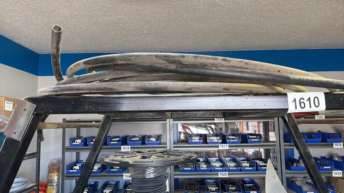 NEW/UNUSED COIL OF BLACK PLASTIC HOSE