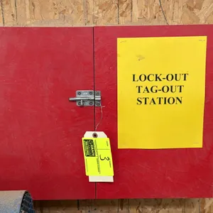 Wall-mount lock-out tag-out cabinet. Features red-painted wood construction, double doors with slide bolt latch, and wall-mount design. Includes assor