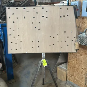 Metal easel with wooden display board. 4'W. Features a framed wood board mounted on a fabricated steel tripod base.