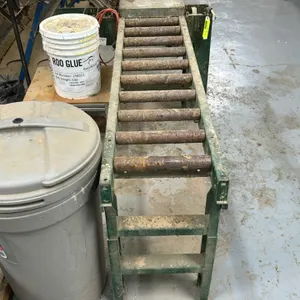 2008 James L. Taylor 171BM3 metal roller conveyor. Features steel frame construction and gravity rollers. 60"L x 16"W. Mounted on steel leg supports.