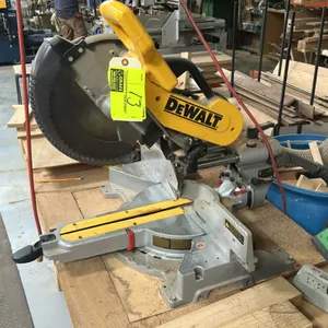 DEWALT DW718 12" double bevel sliding compound miter saw. Features sliding arm mechanism, rotating miter base, and integrated blade guard. S/N: 055080