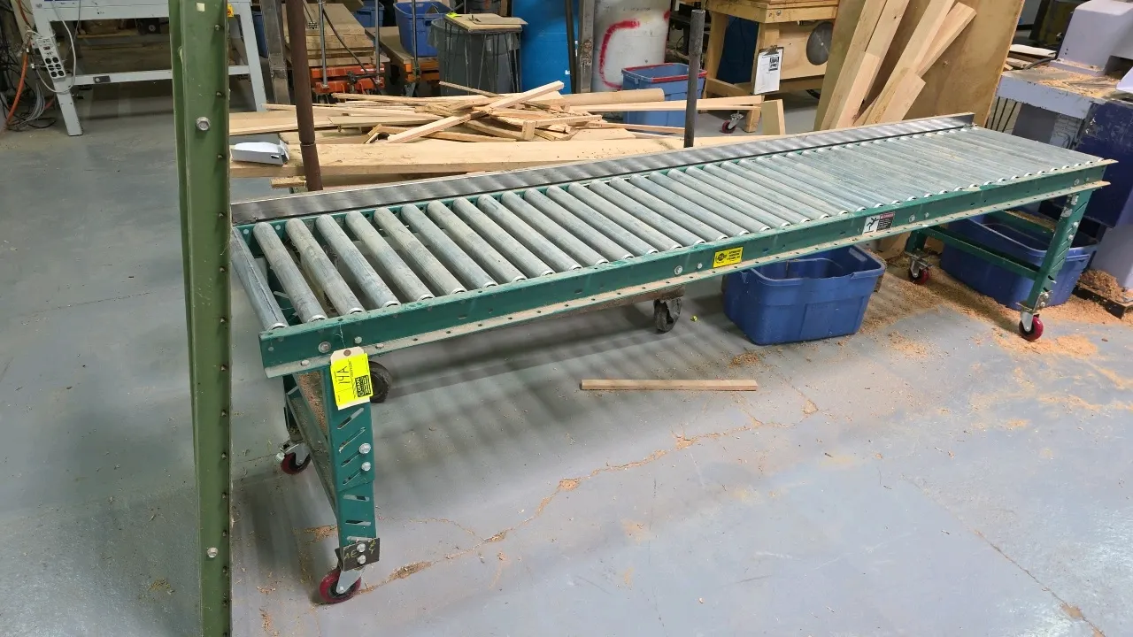 Portable roller conveyor. Includes a 10'L x 2'W mobile roller track mounted on adjustable-height legs with swivel casters and side guide rail, along w
