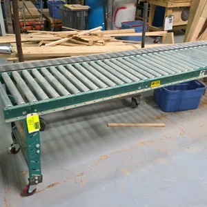 Portable roller conveyor. Includes a 10'L x 2'W mobile roller track mounted on adjustable-height legs with swivel casters and side guide rail, along w
