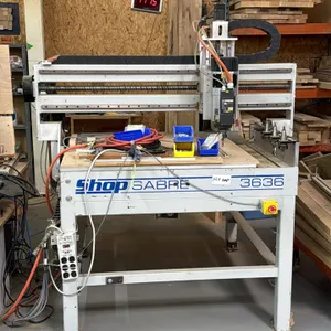 Shop Sabre 3636 3-axis CNC router table. Features 3' x 3' working area, HSD spindle, linear tool holder rack with tool holders, and cable carrier trac