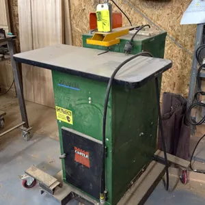 Castle TSM-21 pocket and pilot hole machine. Features pneumatic hold-down clamp, foot pedal control, dust collection port, and laminate work top. Moun
