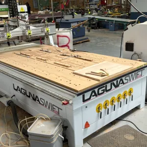 Laguna Swift 4X8 3-axis CNC router. Features a 4' x 8' vacuum table with 6-zone manifold, triple spindle heads, standalone control cabinet with handhe