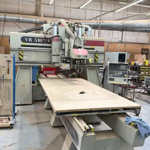 2000 Komo VR 510 Mach III CNC router. Features automatic tool changer, GE Fanuc control console, mobile computer station, and Quincy industrial inline