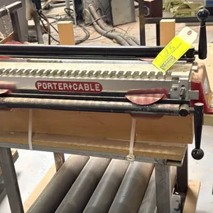 Porter-Cable 7116 OMNIJIG 24" dovetail machine. Features template guides, clamping bars, and adjustment wrenches. S/N: 035329. Mounted on a wood box a