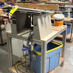 Porter-Cable router table with Porter-Cable router and stand. Features a wooden fence attachment, integrated power switch, and an aluminum extrusion f