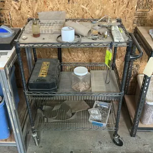 3-tier metal wire utility cart. Includes DeWALT hard tool case, hardware organizers, fasteners, and remaining shelf contents. 34" x 18". Features inte