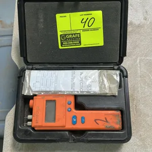 Delmhorst HT-3000 handheld thermo-hygrometer. Features digital LCD screen, integrated contact pins, and push-button controls. Includes Delmhorst molde