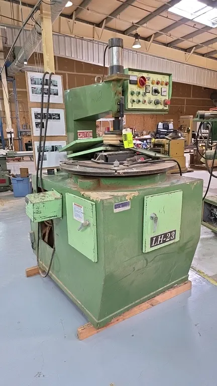 Champ Fond LH-23 automatic copy inner shaping machine. Features overhead pneumatic hold-down clamp, rotary table, front control console, pneumatic reg