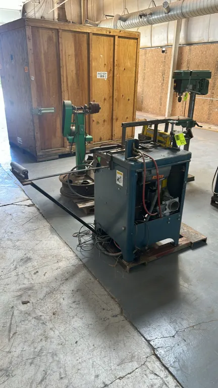 Whirlwind 212 Series 1000L industrial upcut saw. Features pneumatic material clamp, blade guard, side extension arm with support roller, and dust coll