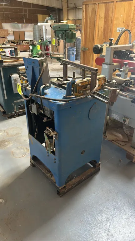 Whirlwind 212 Series 1000L industrial upcut saw. Features pneumatic top clamping, infeed and outfeed roller support arm, side-mounted air filter and r