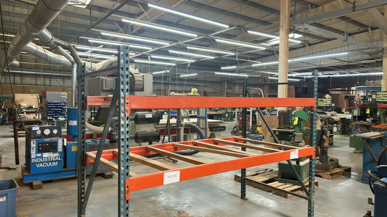 2-tier metal pallet racking. Features teardrop style uprights, orange load beams, and wood deck supports. Dimensions: 101"L x 48"W x 78"H.