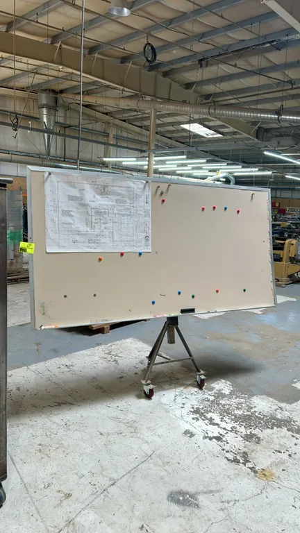 Whiteboard with portable metal easel stand. Features an aluminum frame and marker tray. 8' x 4'. Mounted on a mobile metal stand with casters. Content