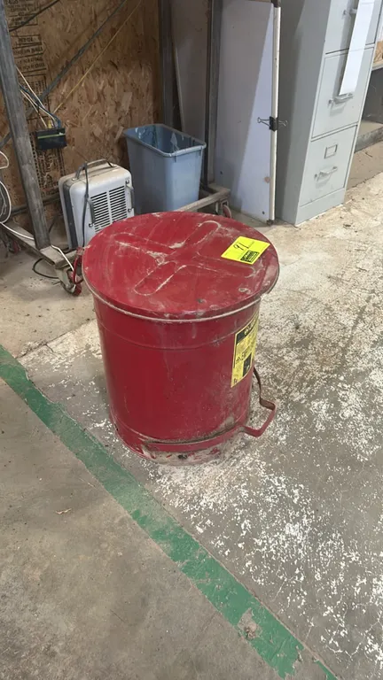 Justrite metal oily waste can. Features foot-operated self-closing lid and carrying handle. Red finish.