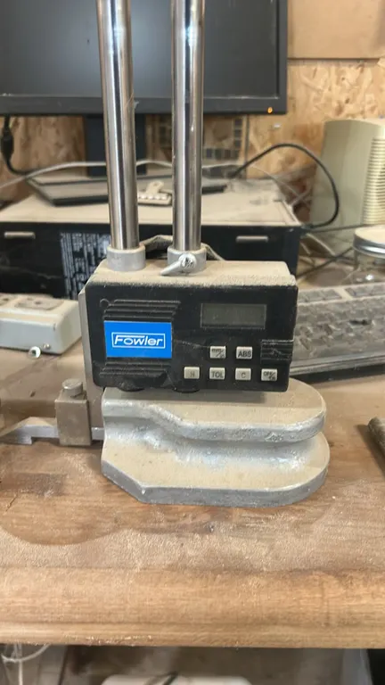 Fowler dual-column electronic height gauge. Features digital LCD display, scriber clamp with scriber, dual cylindrical beams, and cast base.