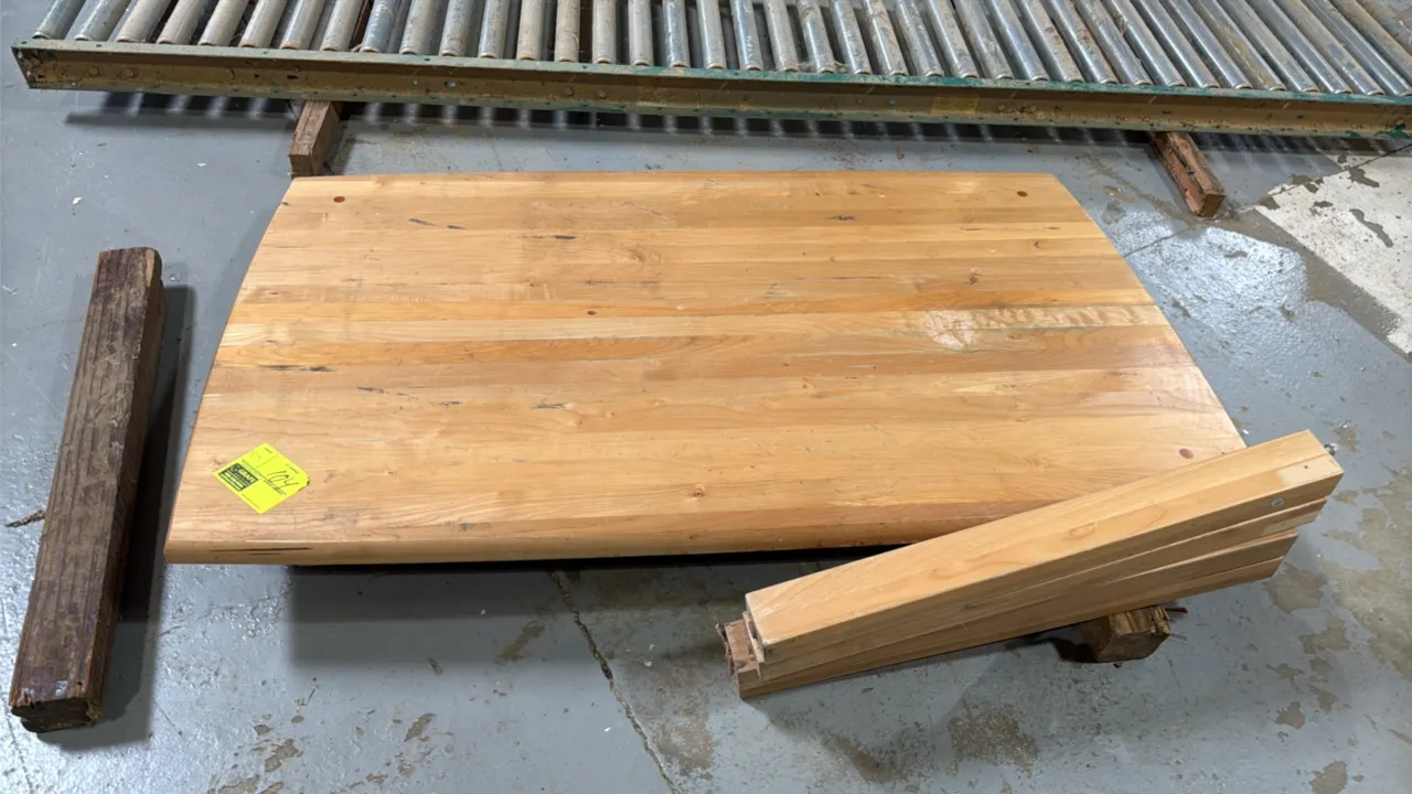 Maple wood butcher block table. Features solid laminated maple top with bullnose front edge and (4) detached wooden legs. Dimensions: 58" x 36".