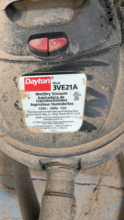 Dayton 3VE21A wet/dry vacuum. Features top carry handle and includes flexible hose. Electrical: 120V, 60 Hz, 12A.