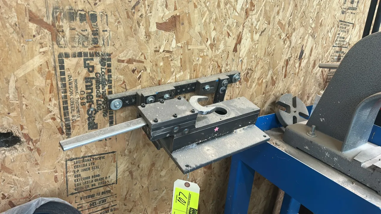 Pneumatic press stock slide feeder. Includes adjustable mounting bracket and adjustment wrench.