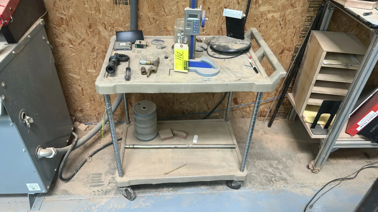 2-tier utility cart. Features 2 molded plastic shelves, integrated push handle, and chrome upright posts. Mounted on casters. Contents not included.