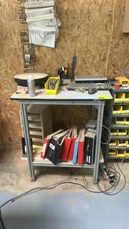 2-tier metal frame standing workstation. Features extruded aluminum frame construction and lower storage shelf. Includes monitor, keyboard, mouse, des