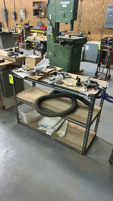 Metal 3-tier shelving rack. 48" x 18". Includes locking C-clamps, assorted wood pieces, plastic storage bins, vacuum hose, miter gauge, hardware, and