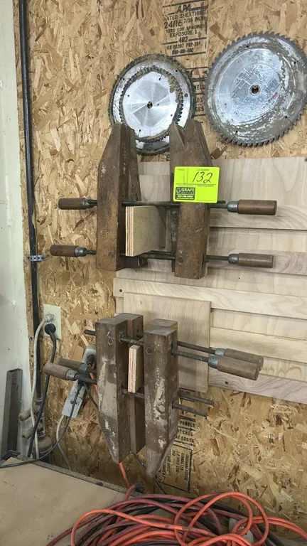 Craftsman wooden handscrew clamps. Features hardwood jaws with dual threaded steel spindles and wooden handles. Mounting board, blades, and background