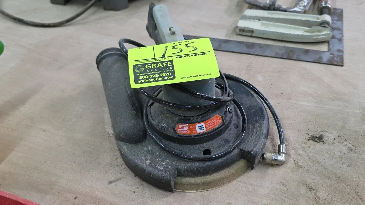 Dynabrade 58414 pneumatic disc sander. Features dust collection shroud and exhaust port, multi-hole sanding backing pad, and top lever control. S/N: 7