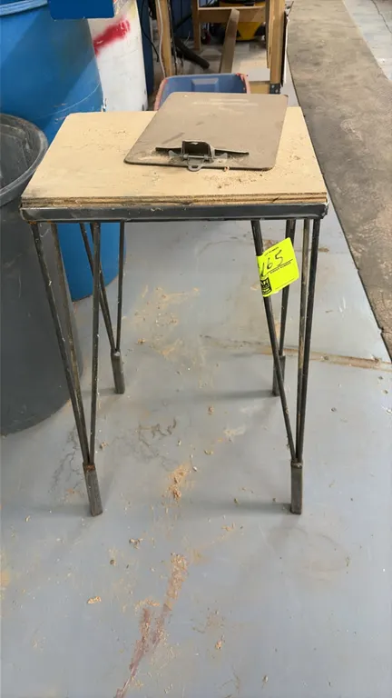 Metal table. Features a wood top and metal hairpin-style legs. Note: Clipboard on top not included.
