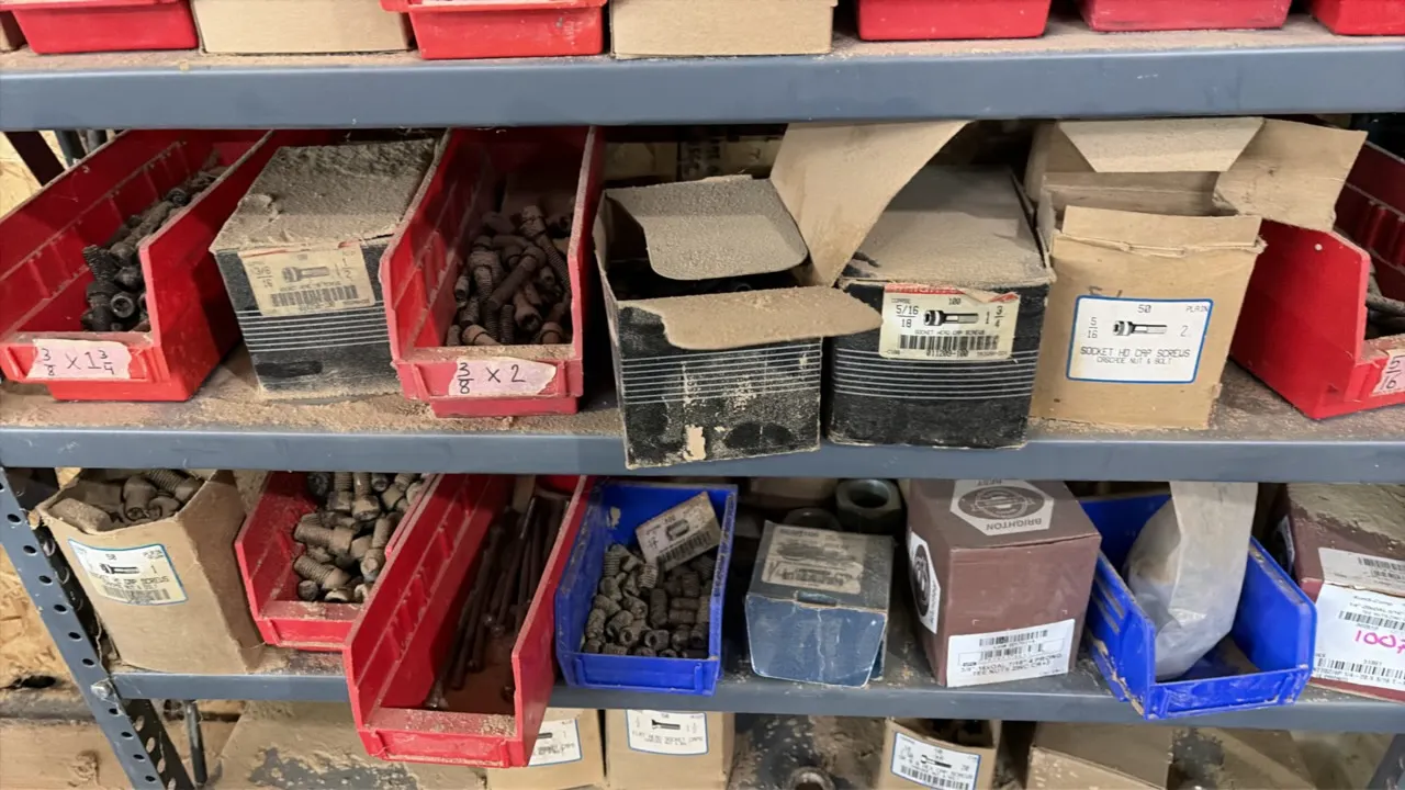 Metal 10-tier shelving rack. Includes assorted hardware consisting of nuts, bolts, screws, miscellaneous parts, and plastic organizer bins. 36"W x 12"