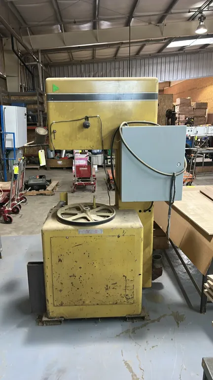 Powermatic 81 industrial vertical bandsaw. Features attached electrical control box, adjustable work lamp, and dust collection port. S/N: 9881070. Not