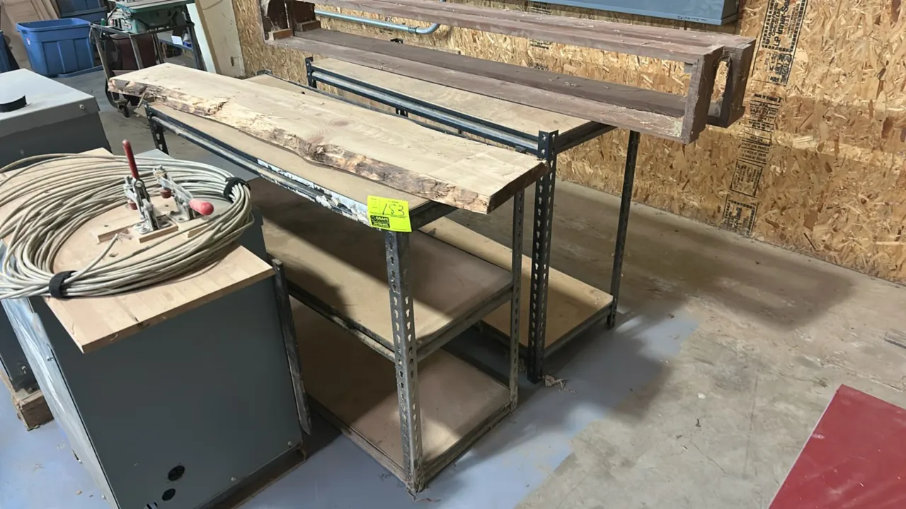 Metal storage shelving racks. Includes (1) 3-tier unit and (1) 2-tier unit featuring slotted metal angle uprights and wood shelf decking. 48" x 18". C