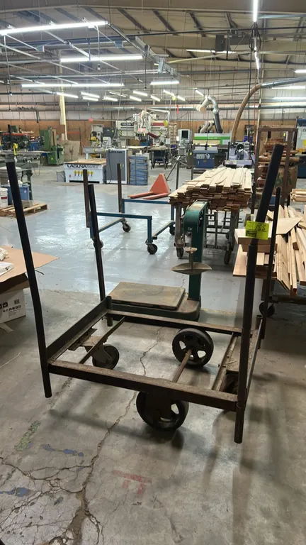 Metal portable shop cart. Features heavy-duty welded steel open frame construction with four vertical corner upright posts. 53" x 38". Mounted on cent