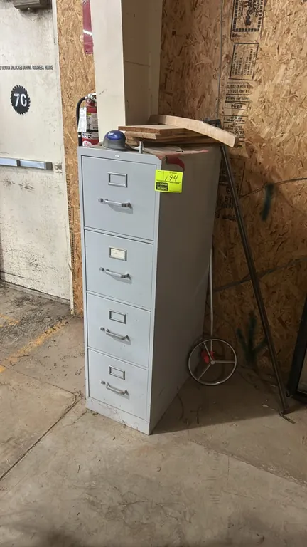 4-drawer metal vertical file cabinet. Features 4 pull-out drawers with integrated label holders and silver-tone pull handles. Gray painted finish. Ite
