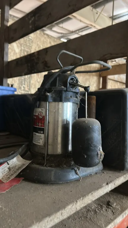 Assorted equipment and pallet racking contents lot. Includes 1/3 HP submersible sump pump with float switch, industrial right-angle gear motors, hydra