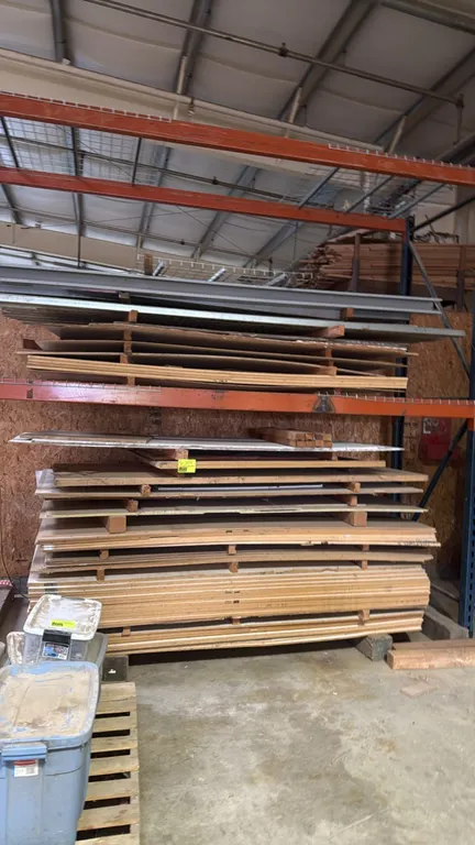 Assorted building materials and hardware lot. Includes various MDF panels, plywood sheets, and slotted metal strut channels and brackets. Note: Pallet