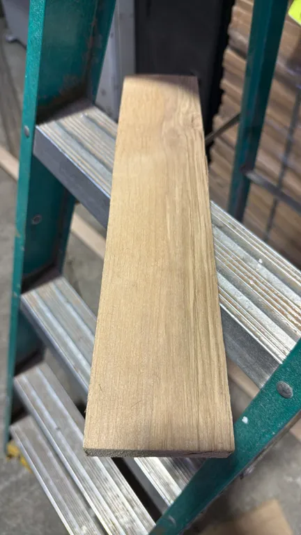 Pallet of cut alder boards. Stacked alder lumber with individual boards measuring approximately 15" x 1". Pallet load measures 32"H. Stepladder in pho